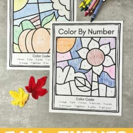 images of the fall color by number worksheets on a table with spilled crayons and two leaves scattered