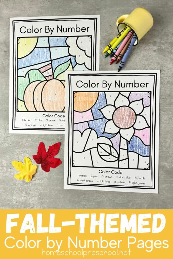 images of the fall color by number worksheets on a table with spilled crayons and two leaves scattered