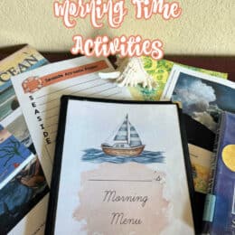 books, printed pages and top page shows a watercolor image of a sailboat on the ocean and "Morning Time" printed