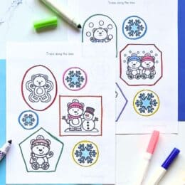 two printed pages showing polar bear themed worksheets spread out on a marbled table top and a few markers