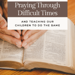 open Bible with female hands folded on top and overlaid text " Praying Through Difficult Times"